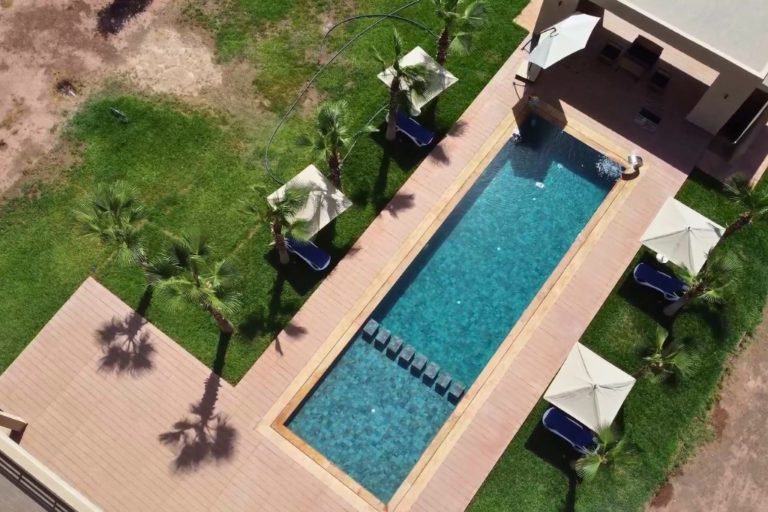 Villa Dar Mazar exterior view with private pool and terrace at sunset near Marrakech Morocco